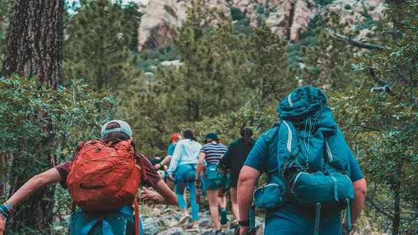 group of people hiking up mountain.