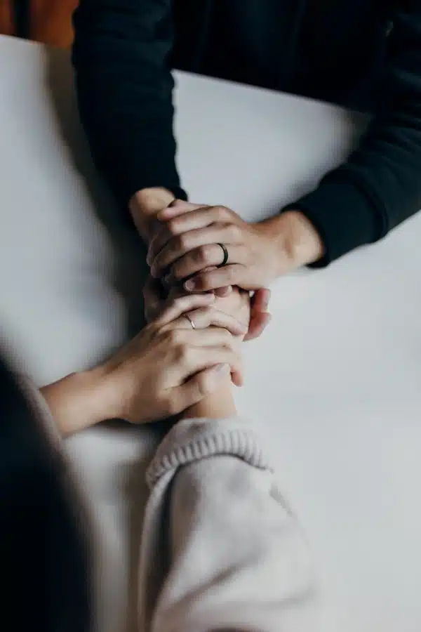 top down view of two people's hands holding.