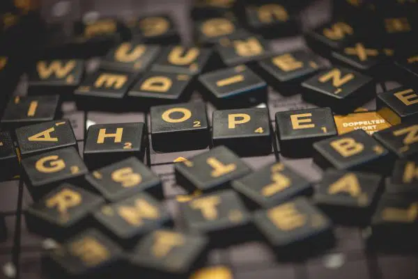 pile of scrabble tiles with letters spelling out HOPE.