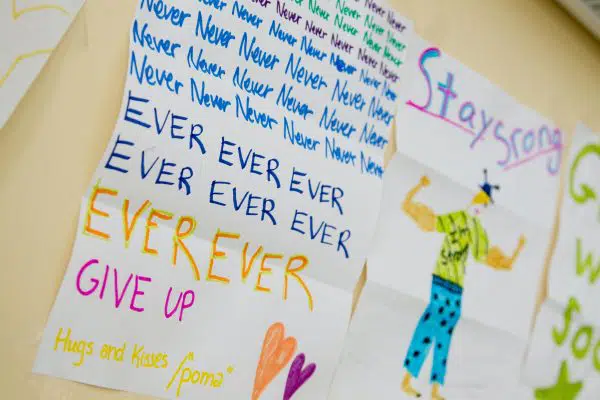 Paper drawings saying Stay Strong and Never ever Ever Give Up.