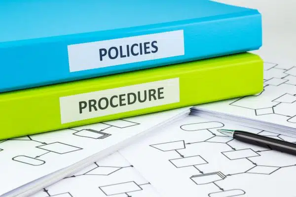 binders labeled "policies" and "procedure".