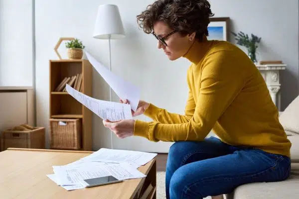 woman sitting and reviewing paperwork.