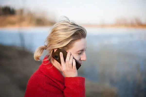woman in red jacket, talking on phone. 