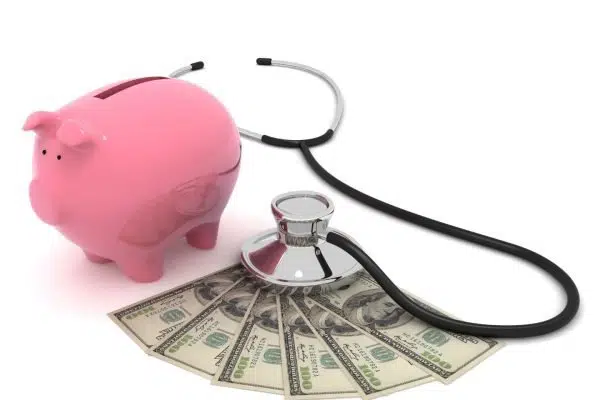 stethoscope, piggy bank, and money splayed out.