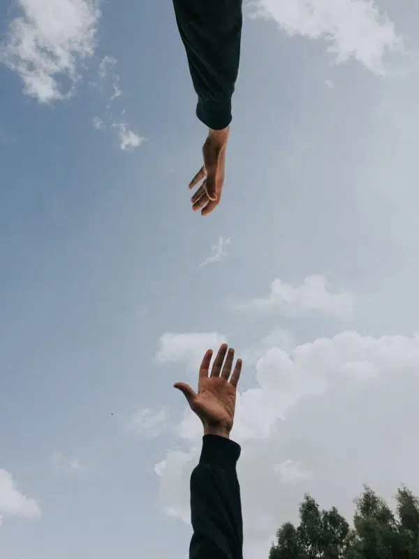 hands reaching towards each other.