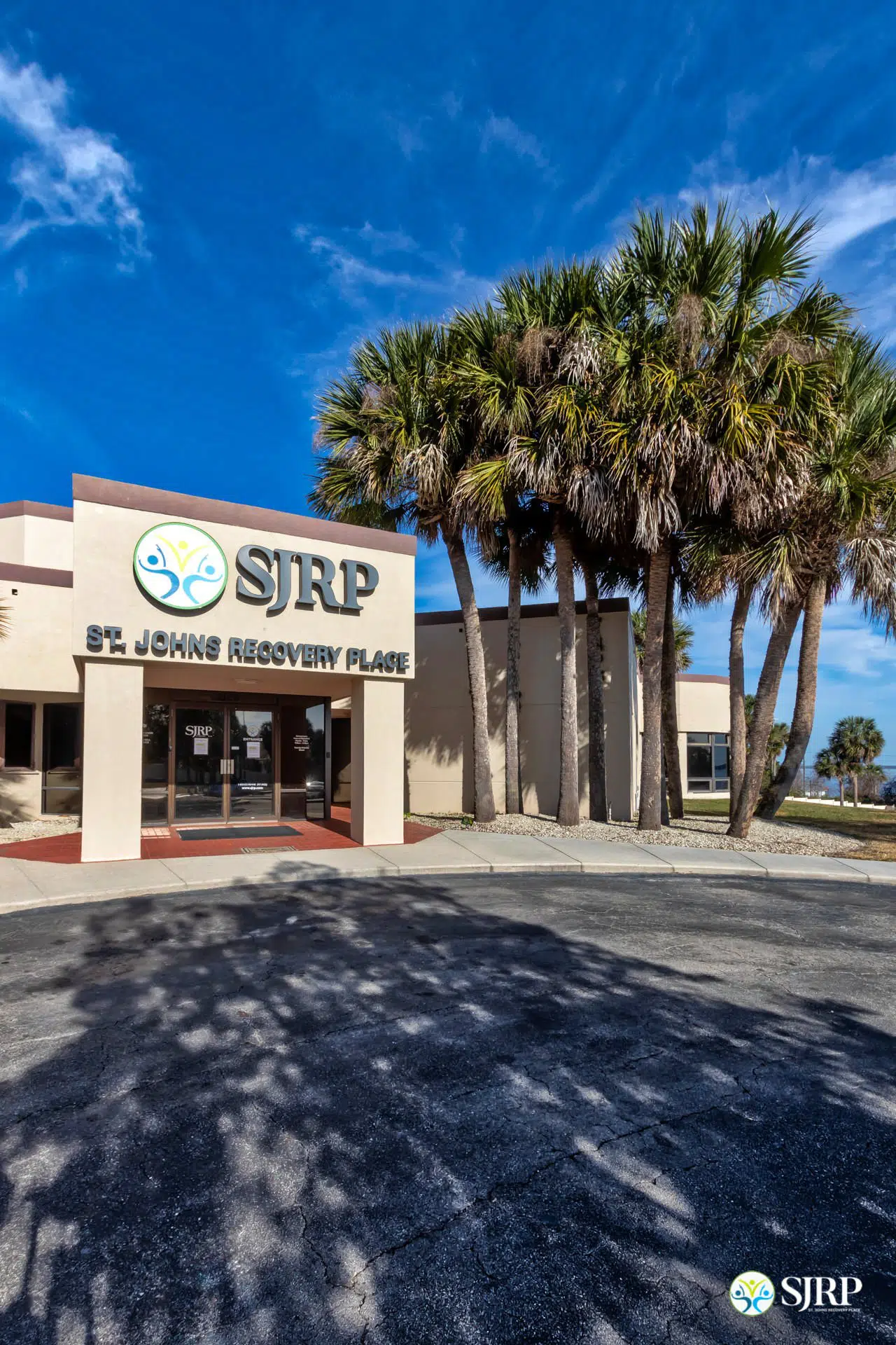 SJRP front entrance angled shot with palm trees on right.