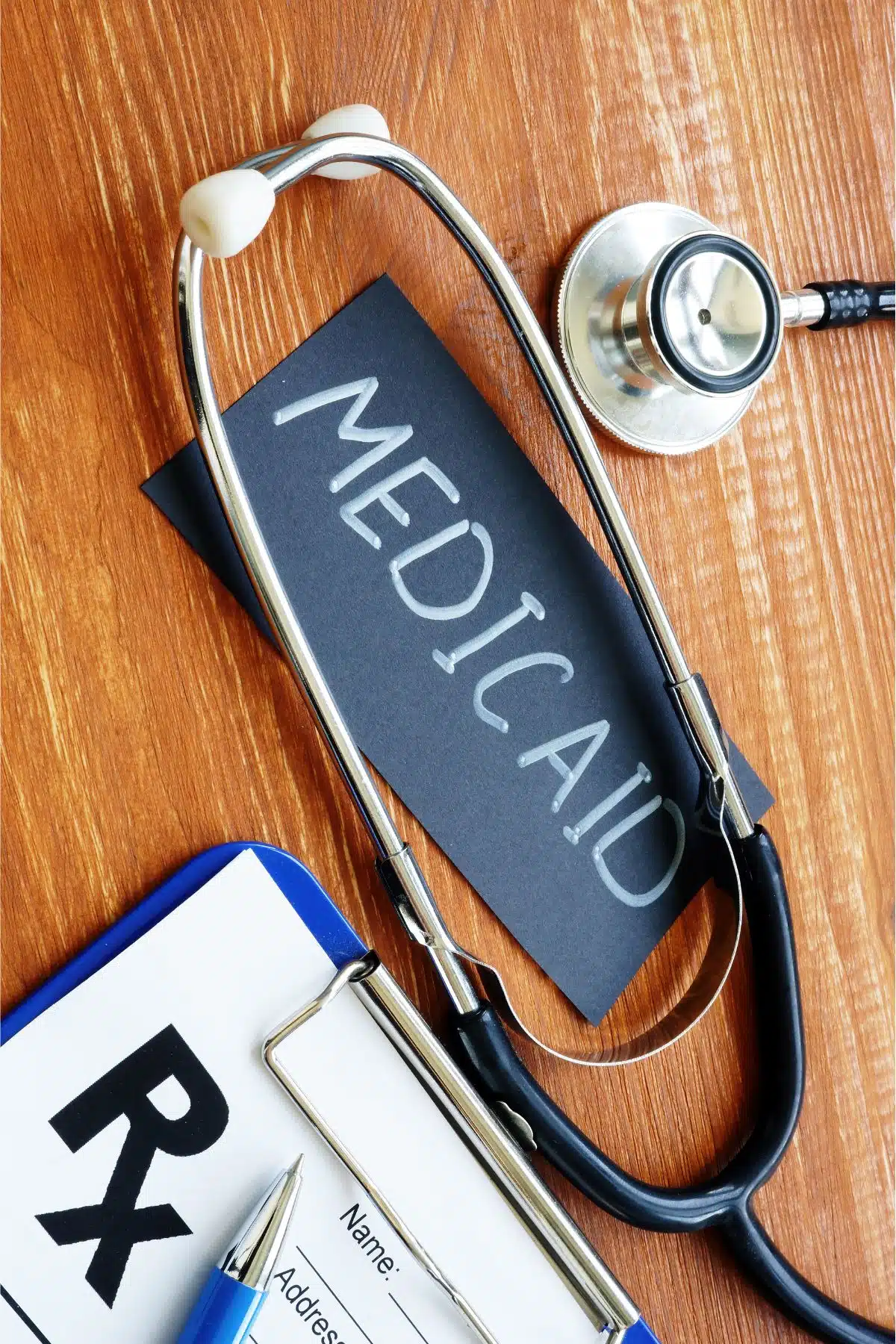 Medicaid sign laying on desk with a stethoscope around it.
